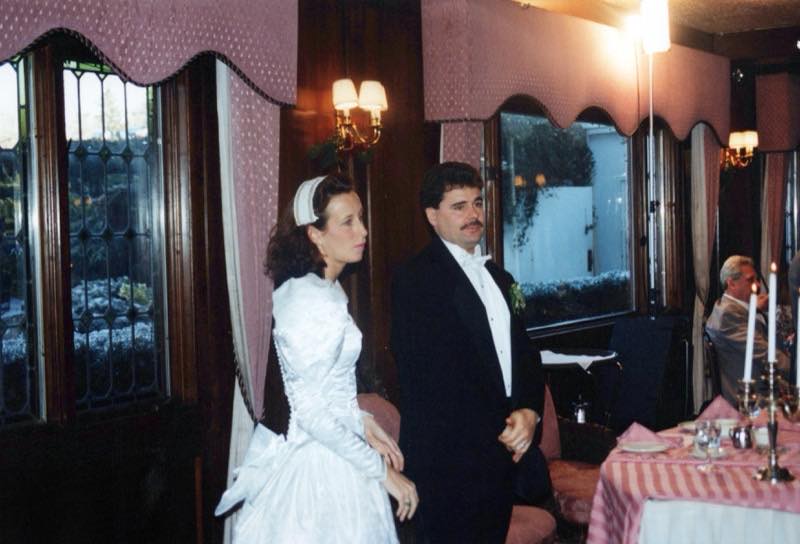 Lou and Rose standing together at a wedding reception