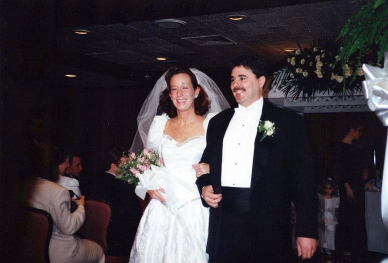 Lou and Rose arm in arm coming down the aisle
